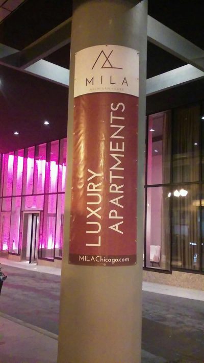 Gamma Imaging printed and installed vinyl banners for MILA on the concrete columns outside the front lobby at their new Luxury Apartment building.